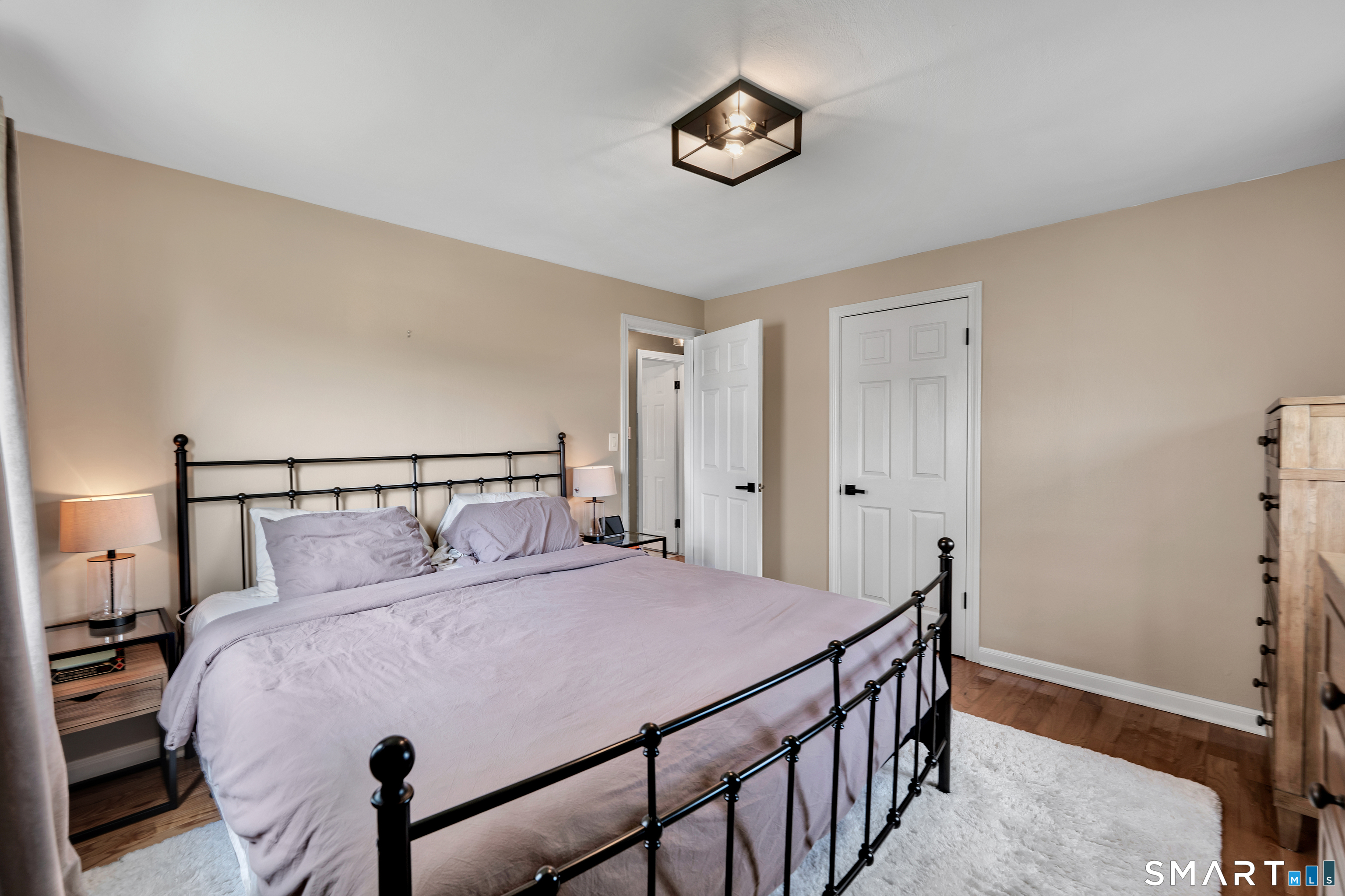 14 Baldwin Street Meriden, CT 06451 - Photo 14 of 35 a bedroom with a bed and a chandelier