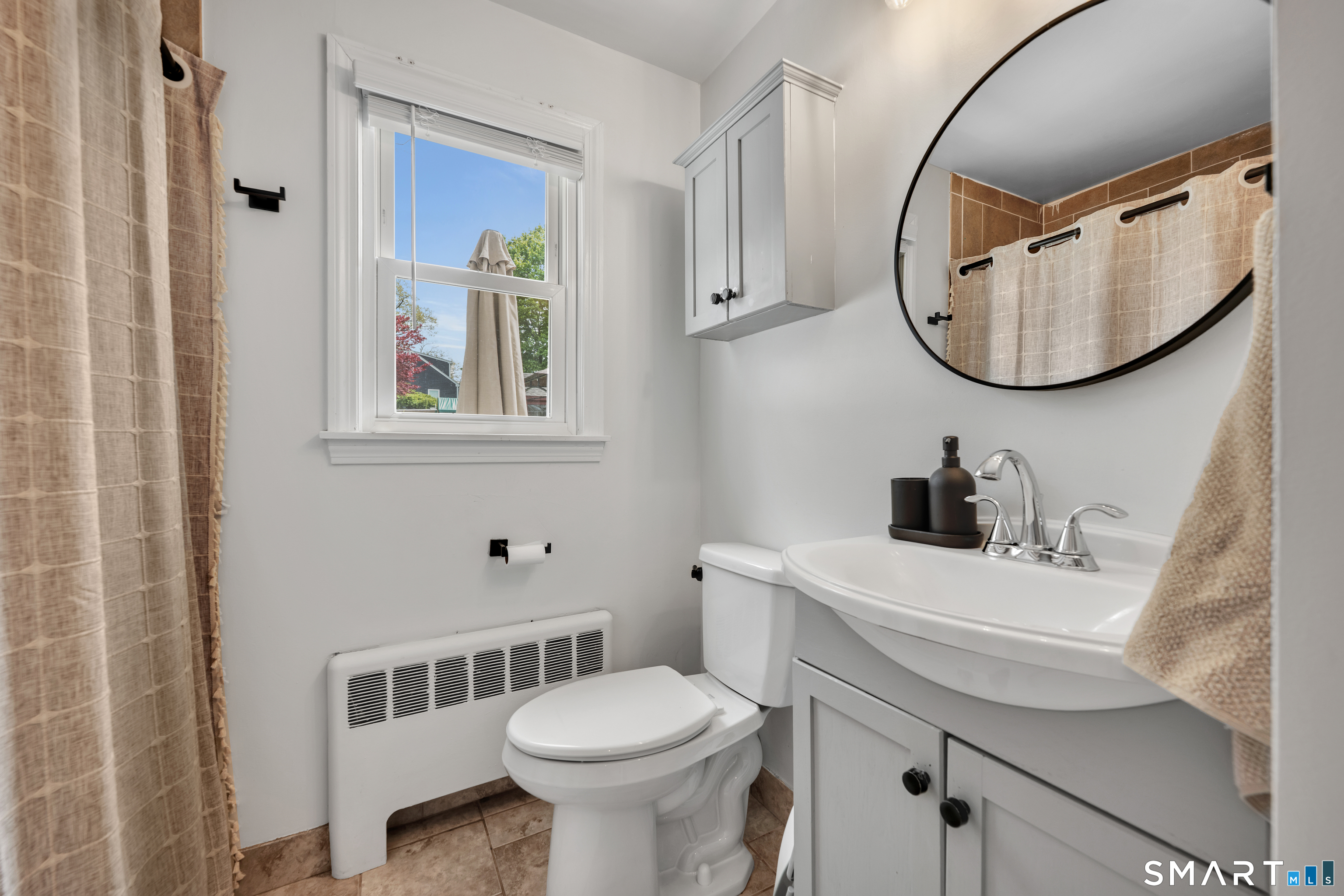 14 Baldwin Street Meriden, CT 06451 - Photo 18 of 35 a bathroom with a sink a mirror a toilet and a mirror