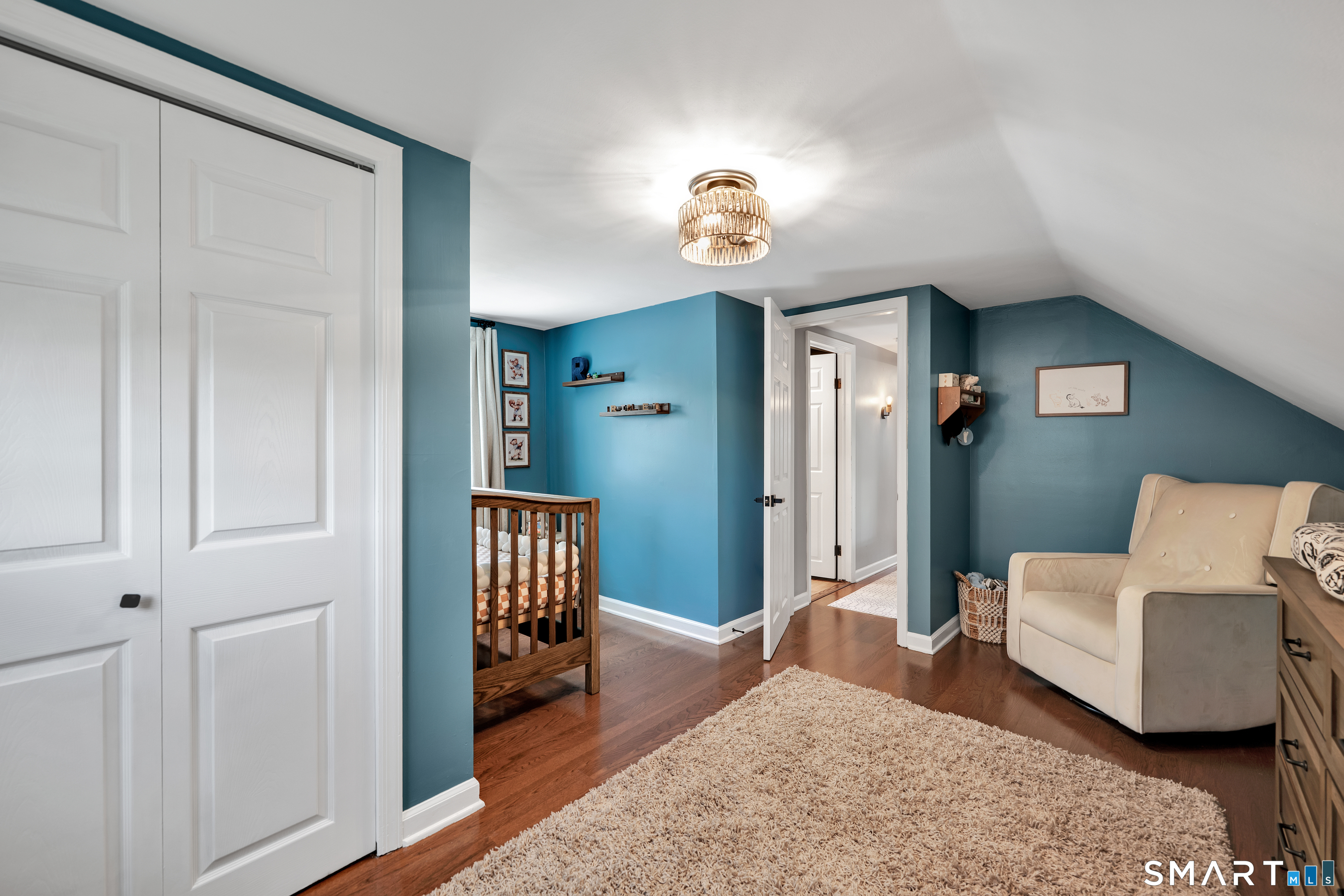 14 Baldwin Street Meriden, CT 06451 - Photo 19 of 35 a bedroom with a bed and a chandelier