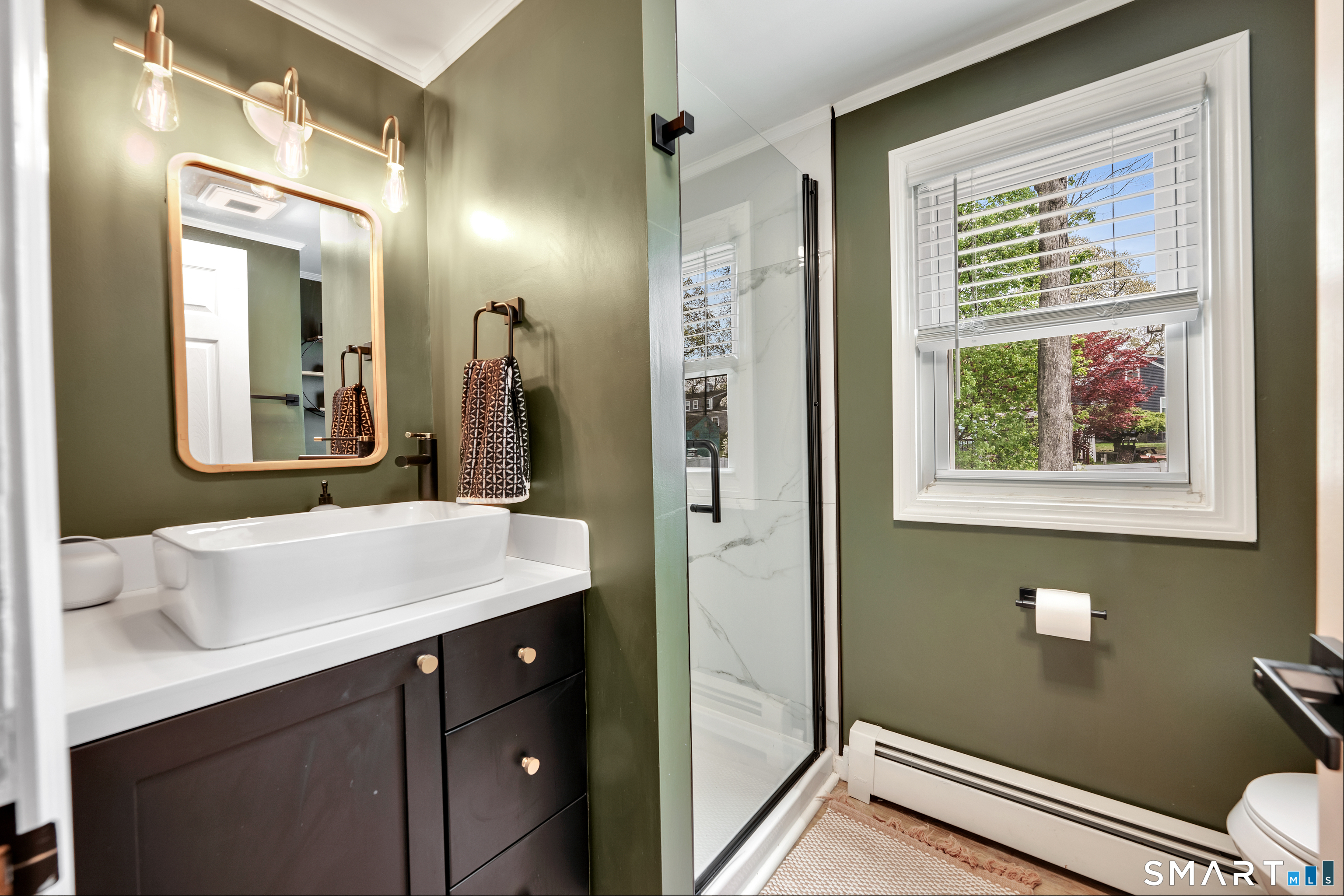 14 Baldwin Street Meriden, CT 06451 - Photo 21 of 35 a bathroom with a sink a mirror and a toilet
