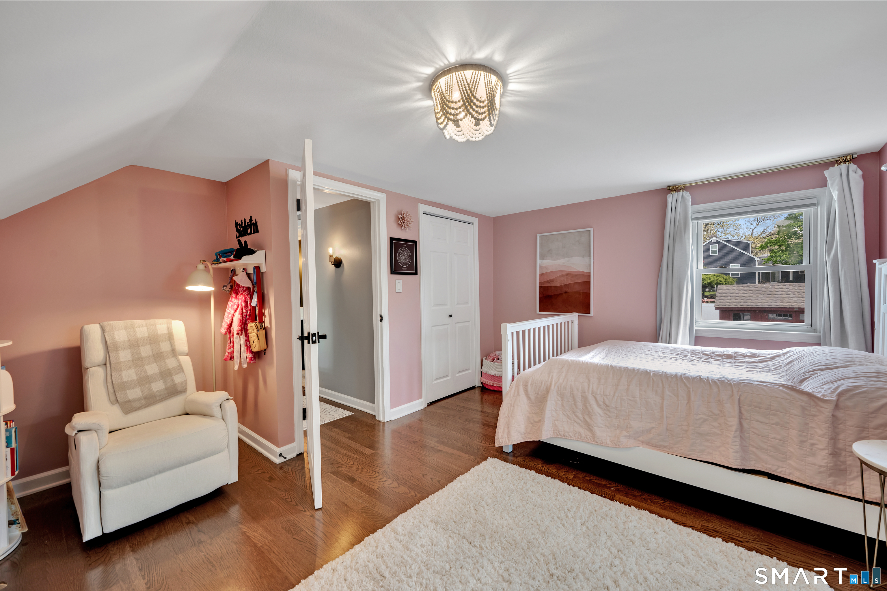 14 Baldwin Street Meriden, CT 06451 - Photo 24 of 35 a bed room with a bed and a chandelier