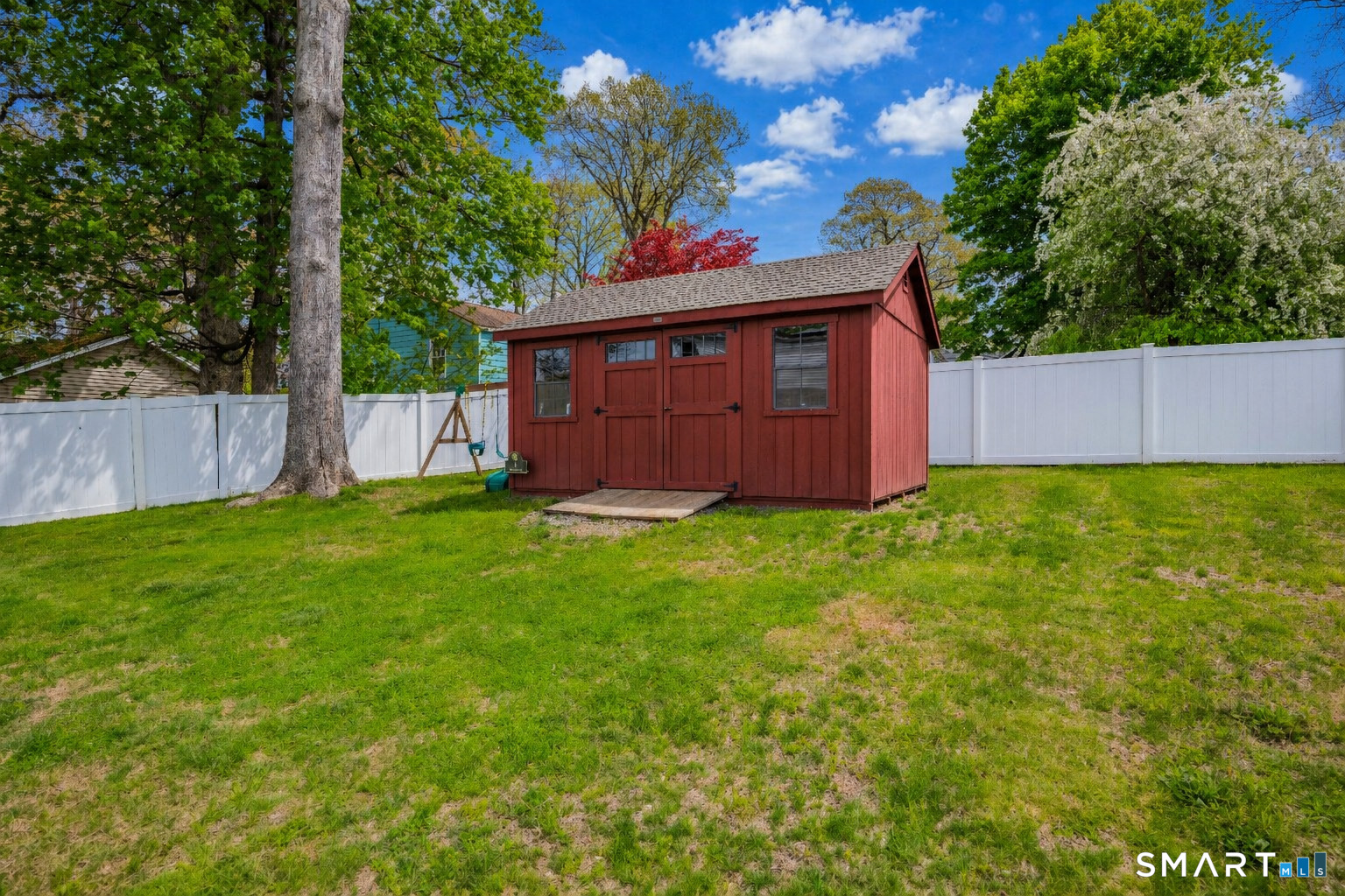14 Baldwin Street Meriden, CT 06451 - Photo 34 of 35 a view of a backyard with potted plants and large tree