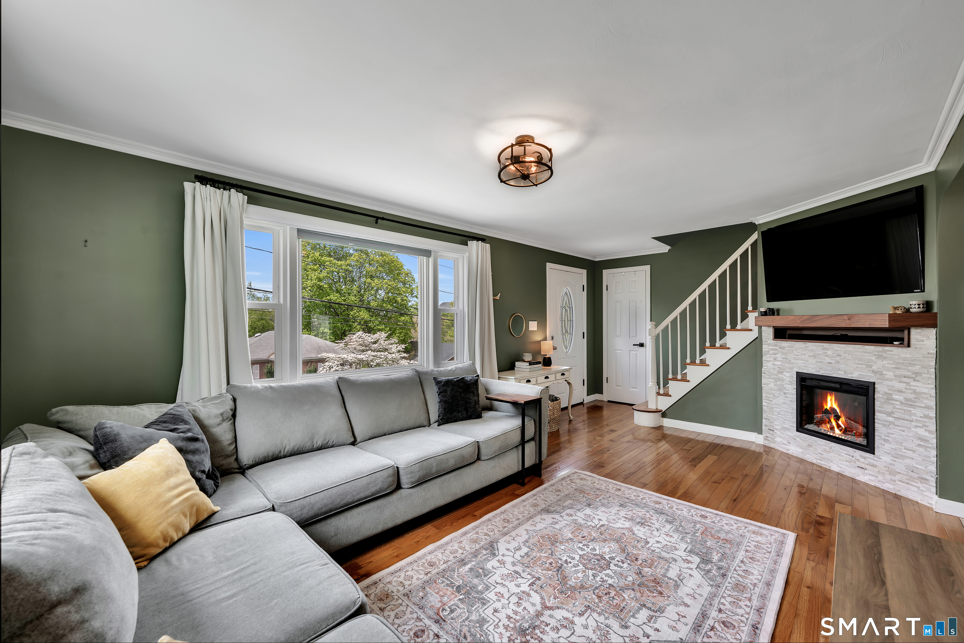 14 Baldwin Street Meriden, CT 06451 - Photo 5 of 35 a living room with furniture flat screen tv and a fireplace