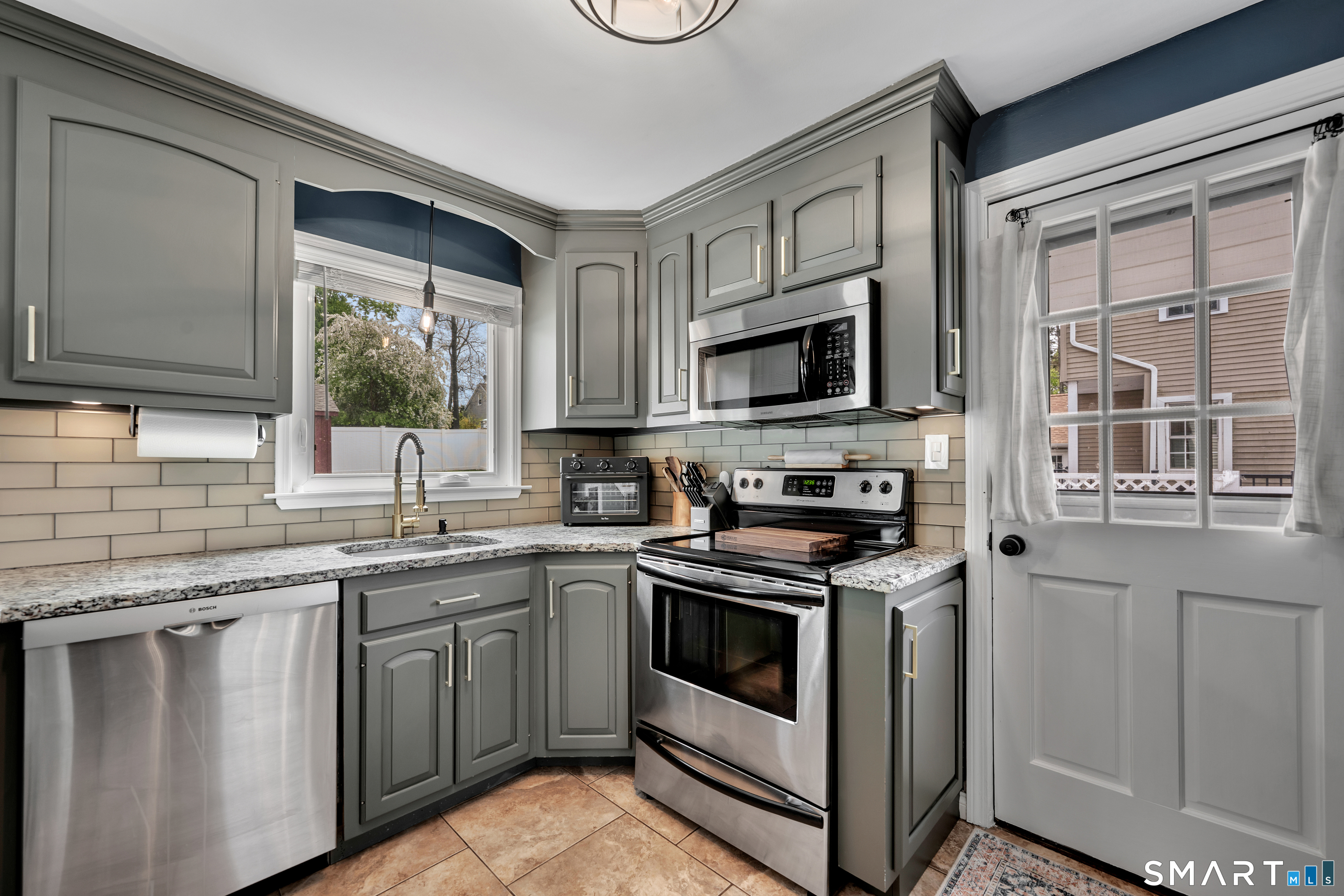 14 Baldwin Street Meriden, CT 06451 - Photo 7 of 35 a kitchen with stainless steel appliances granite countertop a stove sink and microwave