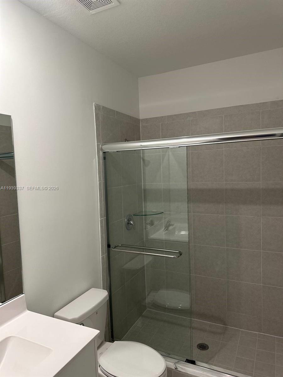 14816 Southwest 265th Street Homestead, FL 33032 - Photo 12 of 16 a bathroom with a toilet and a shower