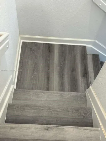 a view of walk in closet with wooden floor