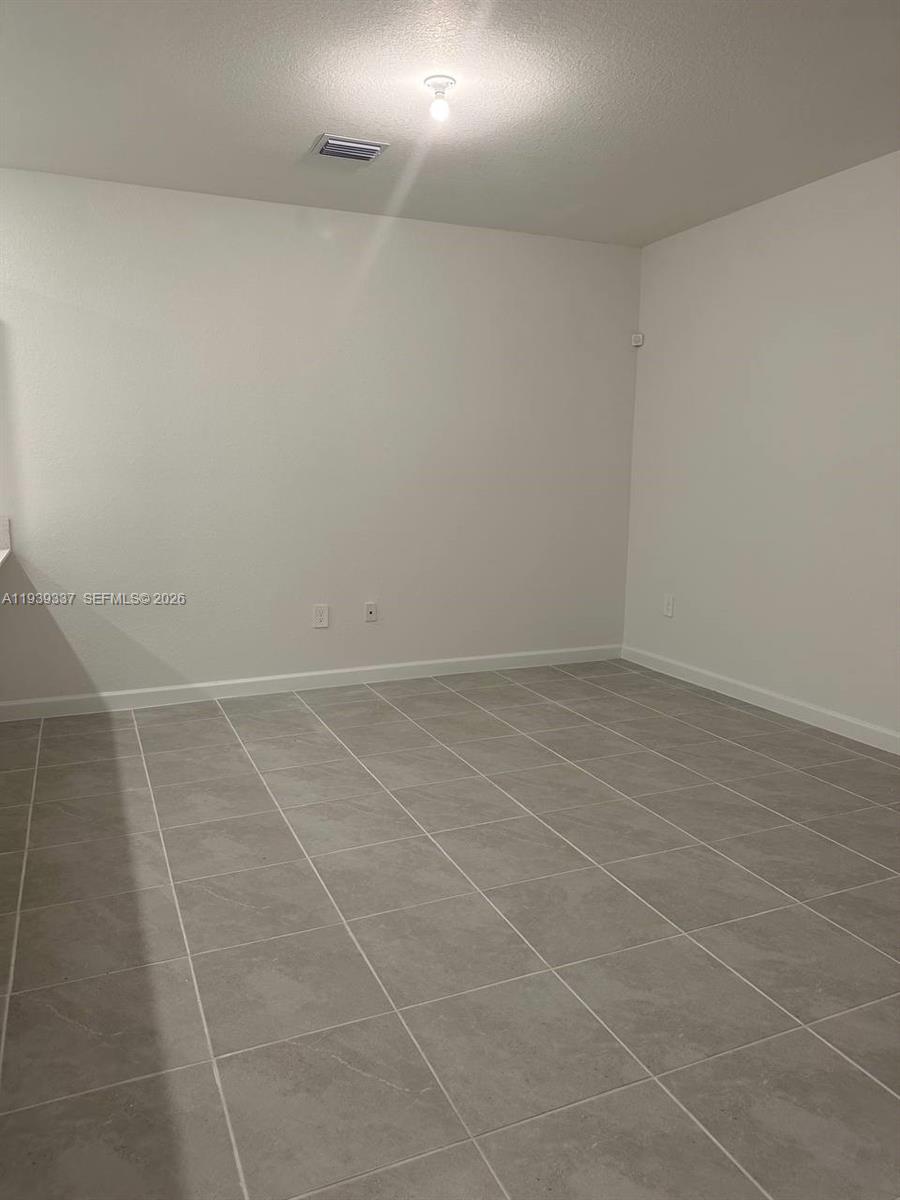 14816 Southwest 265th Street Homestead, FL 33032 - Photo 5 of 16 a view of a room with an empty space and a window