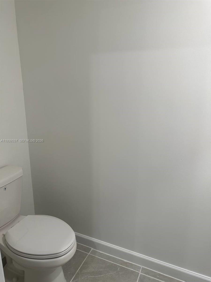 14816 Southwest 265th Street Homestead, FL 33032 - Photo 9 of 16 a white toilet sitting next to a shower