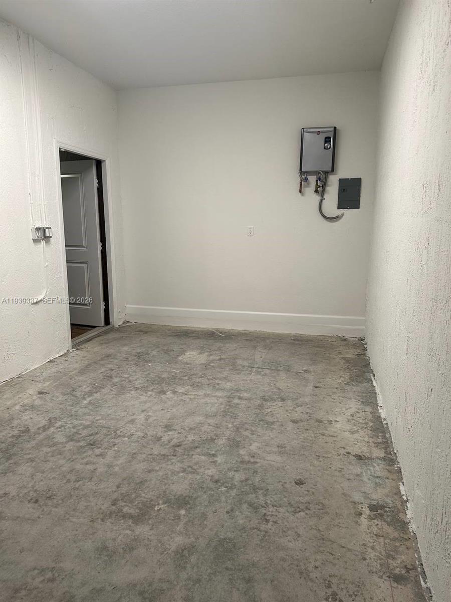 14816 Southwest 265th Street Homestead, FL 33032 - Photo 10 of 16 an empty room with a workbench