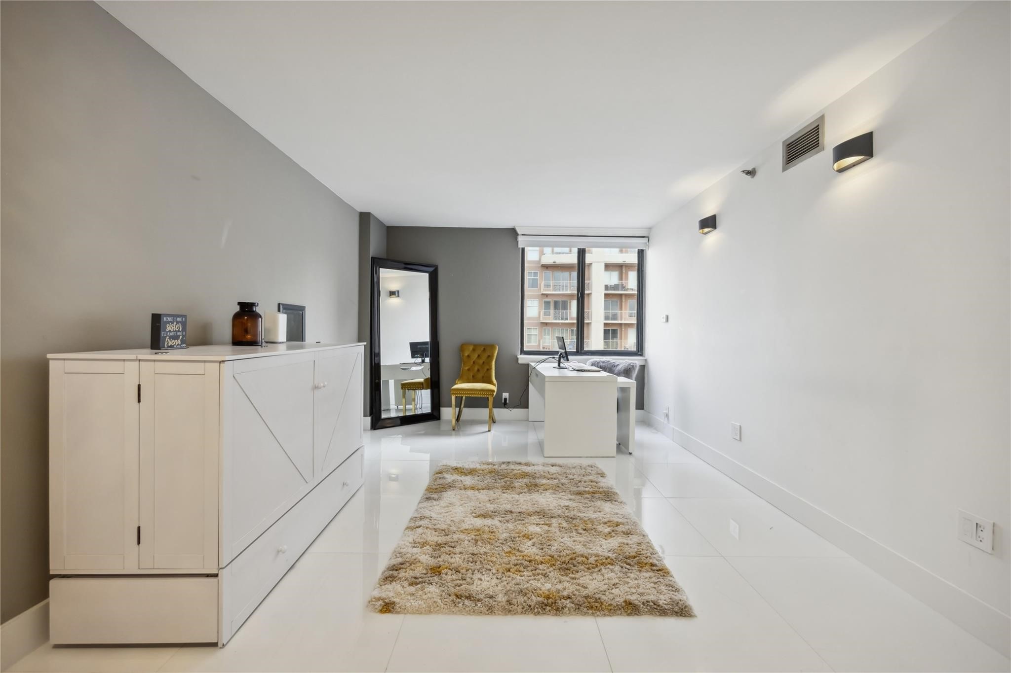 3525 Sage Road, Unit 1713 Houston, TX 77056 - Photo 15 of 25 Ideal for a second bedroom or office set up. Sleek white flooring and neutral walls. It features a large window for natural light, contemporary lighting fixtures.
