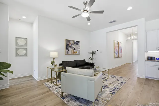a living room with furniture and wooden floor
