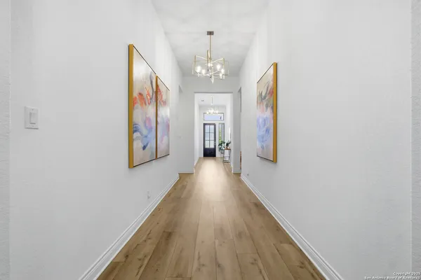 a view of a hallway with wooden floor