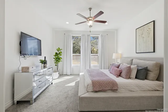 a bedroom with a large bed and a flat screen tv