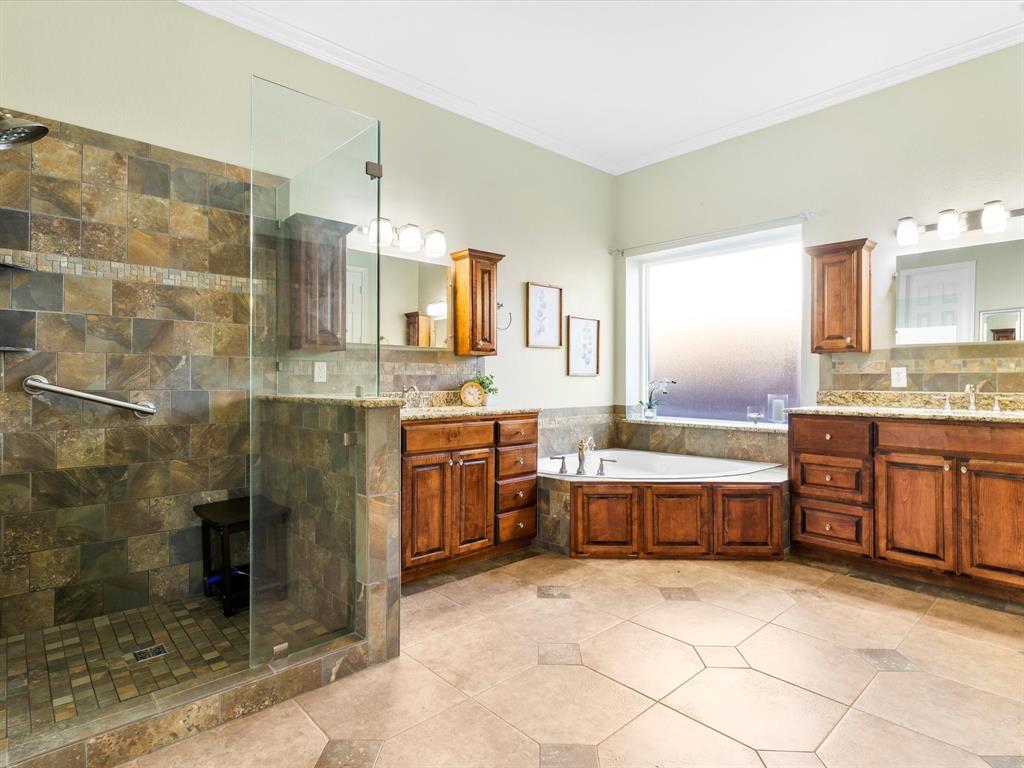 728 Morningside Trail Murphy, TX 75094 - Photo 17 of 40 a large bathroom with a granite countertop sink a toilet and bathtub