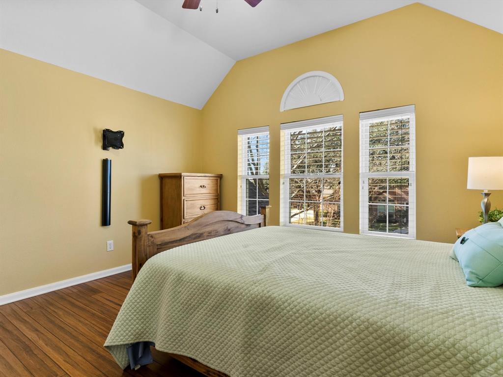 728 Morningside Trail Murphy, TX 75094 - Photo 20 of 40 a bedroom with a bed and wooden floor