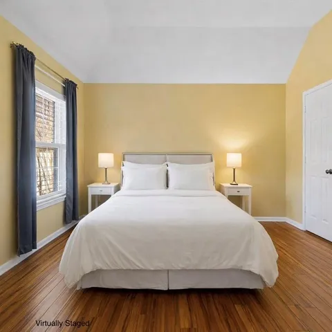 a bedroom with a bed and a large window