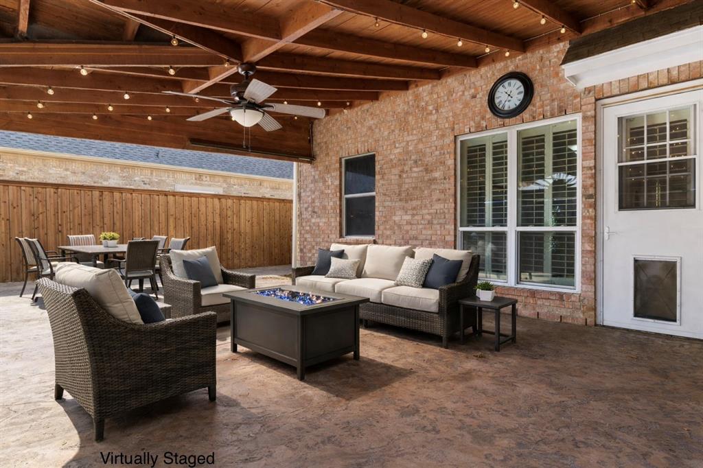 728 Morningside Trail Murphy, TX 75094 - Photo 28 of 40 a living room with furniture a large window and a fireplace