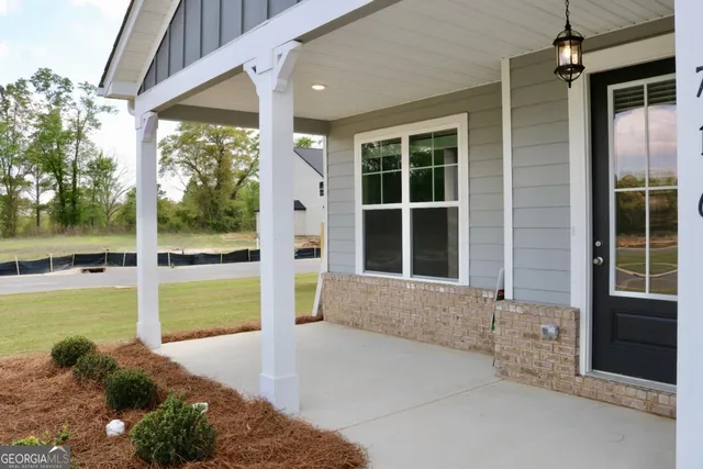 a view of a house with a large window and a yard