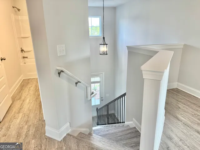 a view of entryway and hall with wooden floor