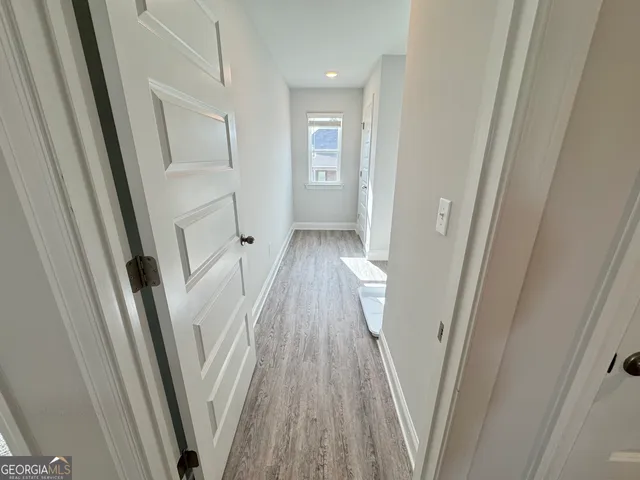 a view of hallway with wooden floor
