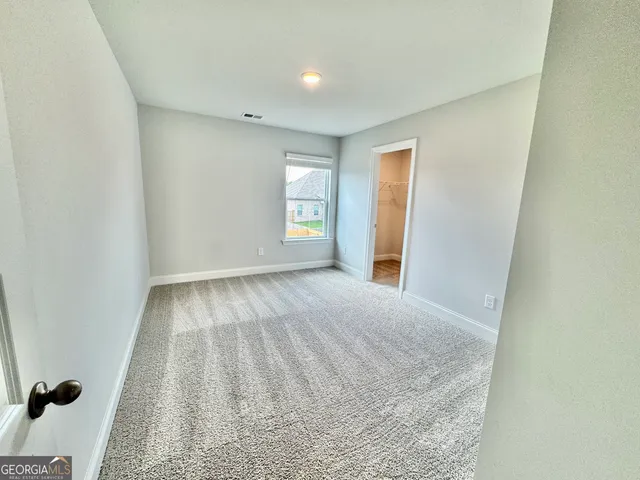 a view of a house with a large window and a yard