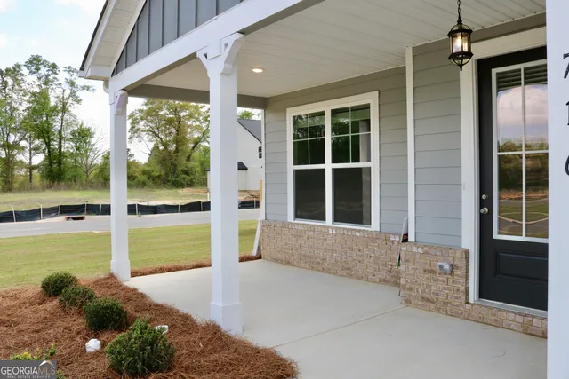 a front view of a house with a yard and fountain