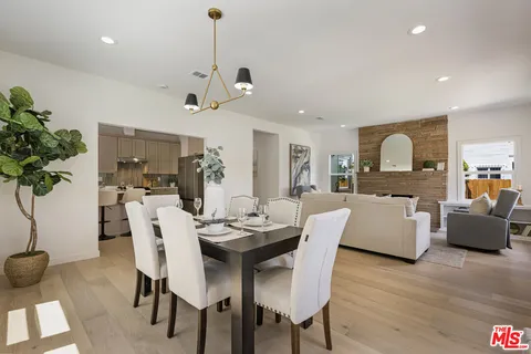 a view of a dining room with furniture wooden floor and chandelier