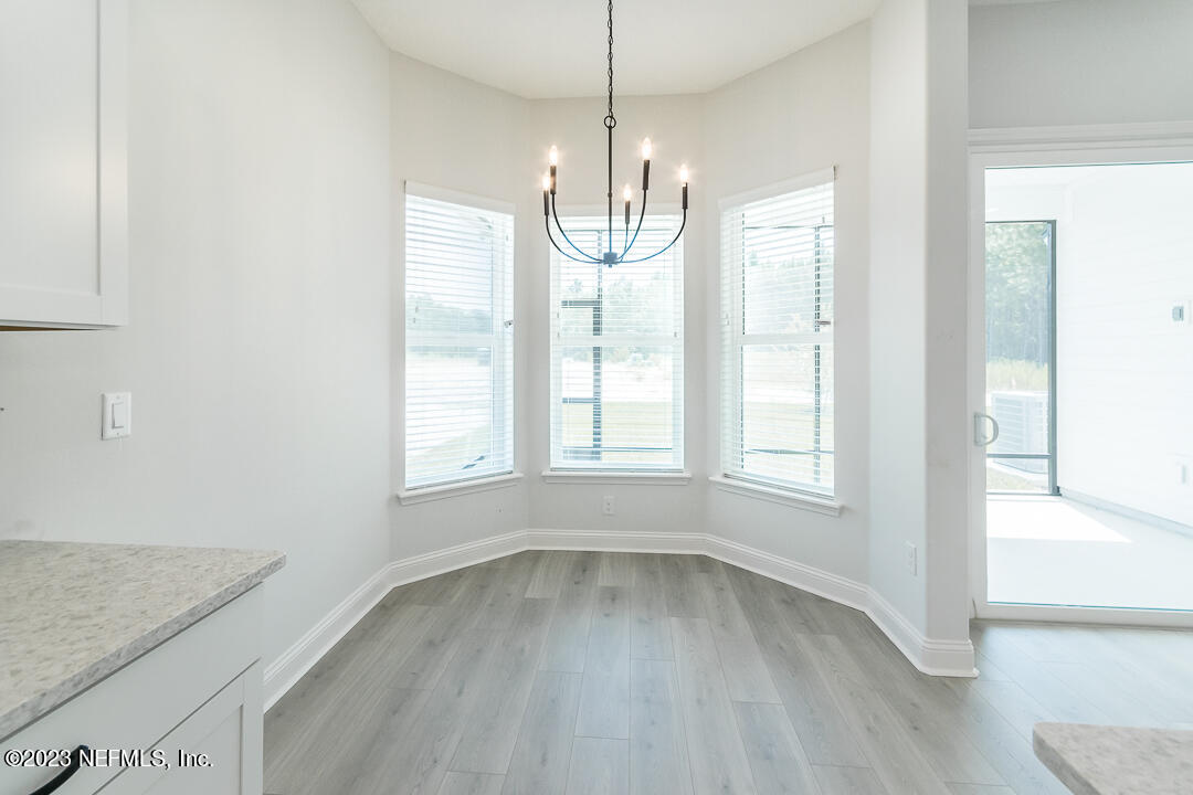 526 Eagle Moon Lake Drive St. Augustine, FL 32092 - Photo 12 of 24 a view of empty room with wooden floor and fan