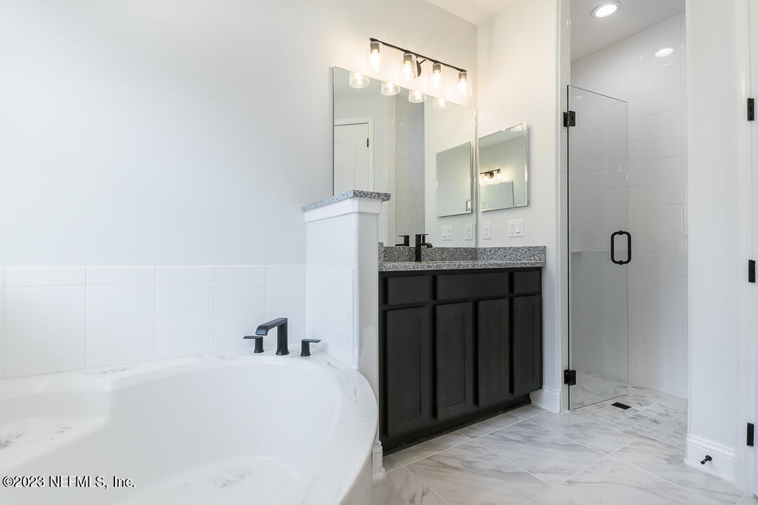 526 Eagle Moon Lake Drive St. Augustine, FL 32092 - Photo 15 of 24 a bathroom with a bathtub and a sink