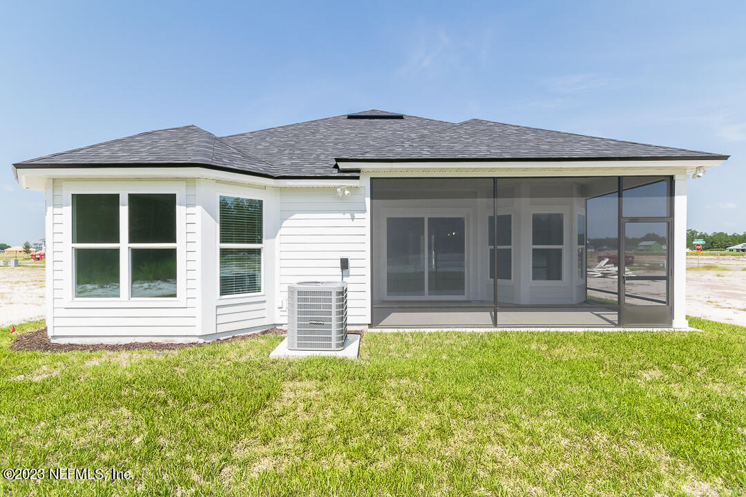 526 Eagle Moon Lake Drive St. Augustine, FL 32092 - Photo 24 of 24 a front view of a house with a garden and yard