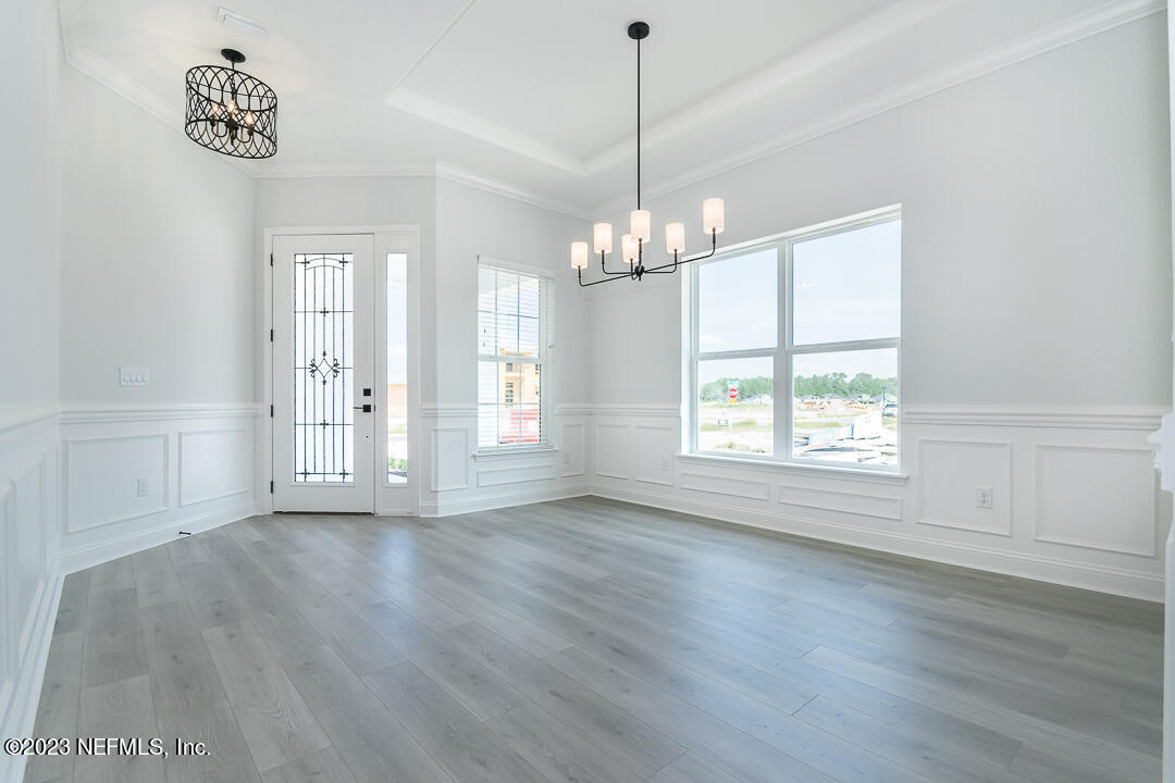 526 Eagle Moon Lake Drive St. Augustine, FL 32092 - Photo 4 of 24 a view of livingroom with window chandelier fan and wooden floor