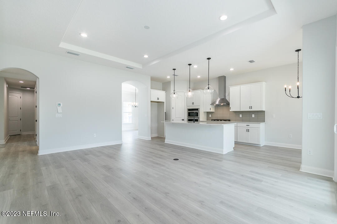 526 Eagle Moon Lake Drive St. Augustine, FL 32092 - Photo 6 of 24 a large kitchen with white cabinets stainless steel appliances and a refrigerator