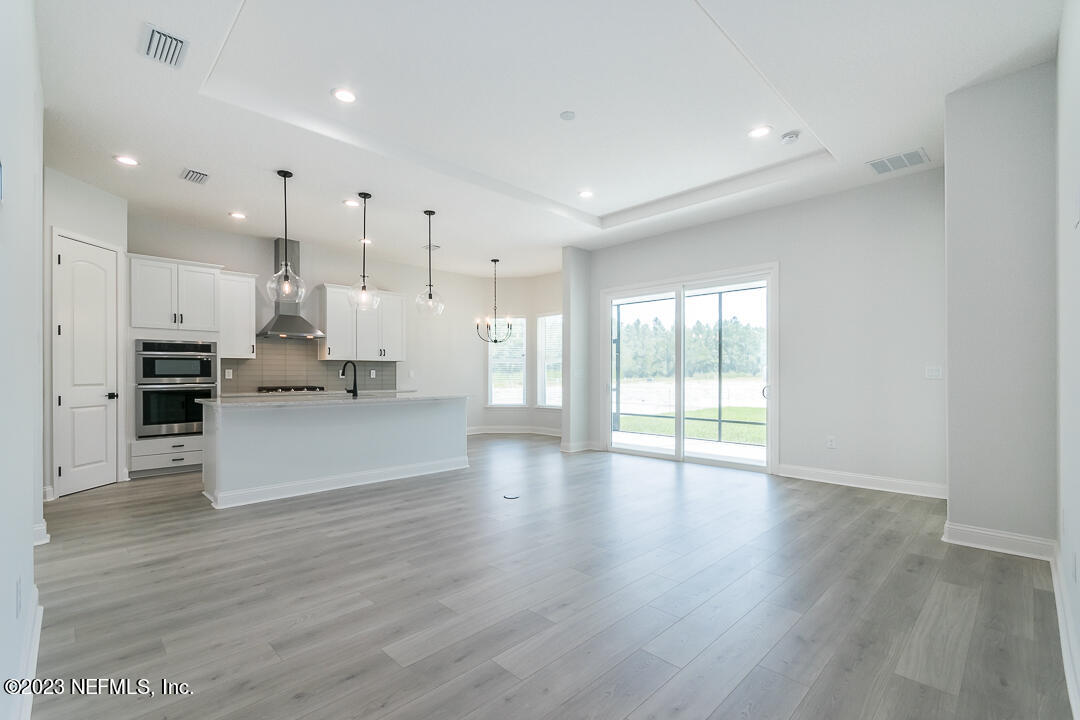 526 Eagle Moon Lake Drive St. Augustine, FL 32092 - Photo 7 of 24 a view of kitchen with kitchen island stainless steel appliances refrigerator stove microwave and cabinets