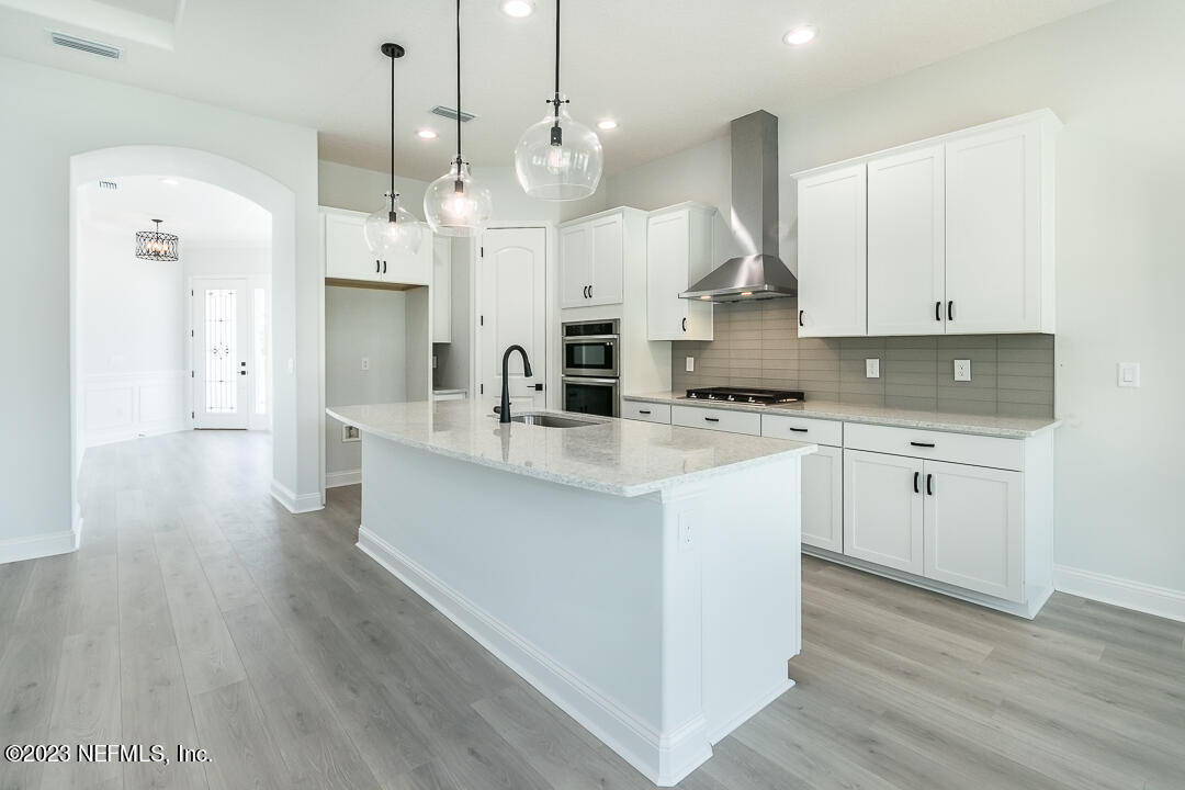 526 Eagle Moon Lake Drive St. Augustine, FL 32092 - Photo 9 of 24 a large kitchen with cabinets and wooden floor