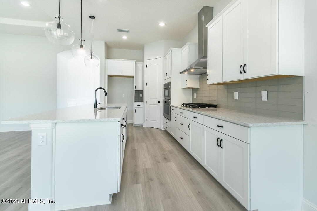 526 Eagle Moon Lake Drive St. Augustine, FL 32092 - Photo 10 of 24 a kitchen with kitchen island granite countertop a sink stainless steel appliances and cabinets