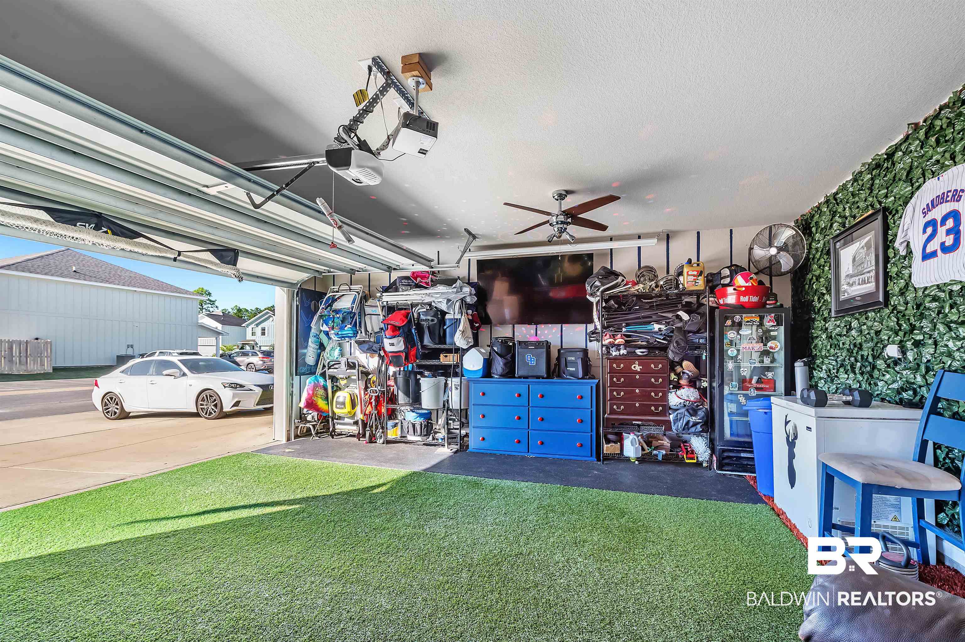 24549 Broken Sound Loop Orange Beach, AL 36561 - Photo 55 of 57 Garage featuring a garage door opener, ceiling fan, and a lawn