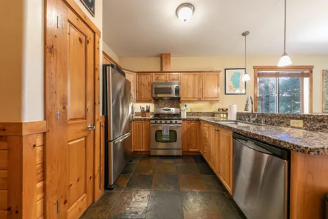 a kitchen with a refrigerator sink and stove