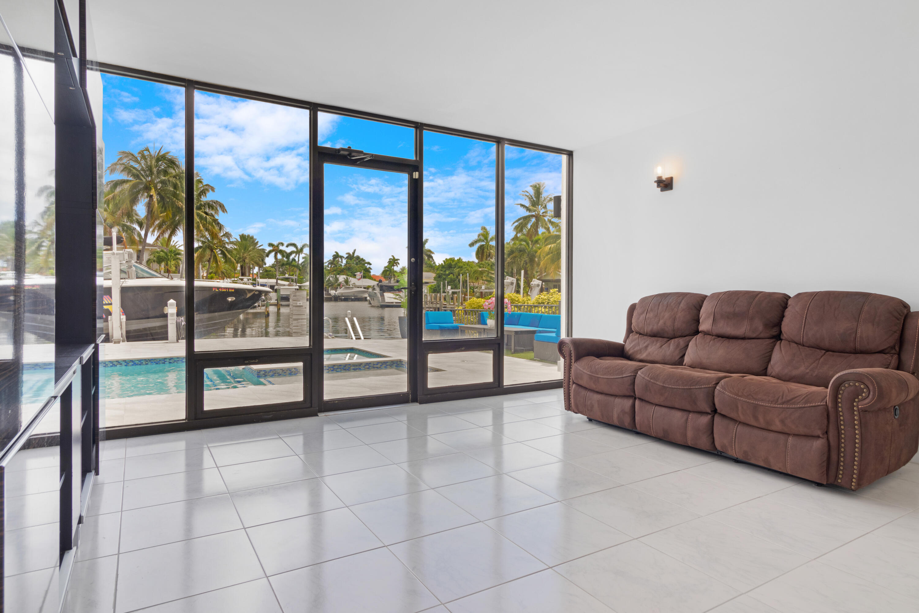 2549 Southeast 9th Street Pompano Beach, FL 33062 - Photo 45 of 73 a living room with a large window and a couch