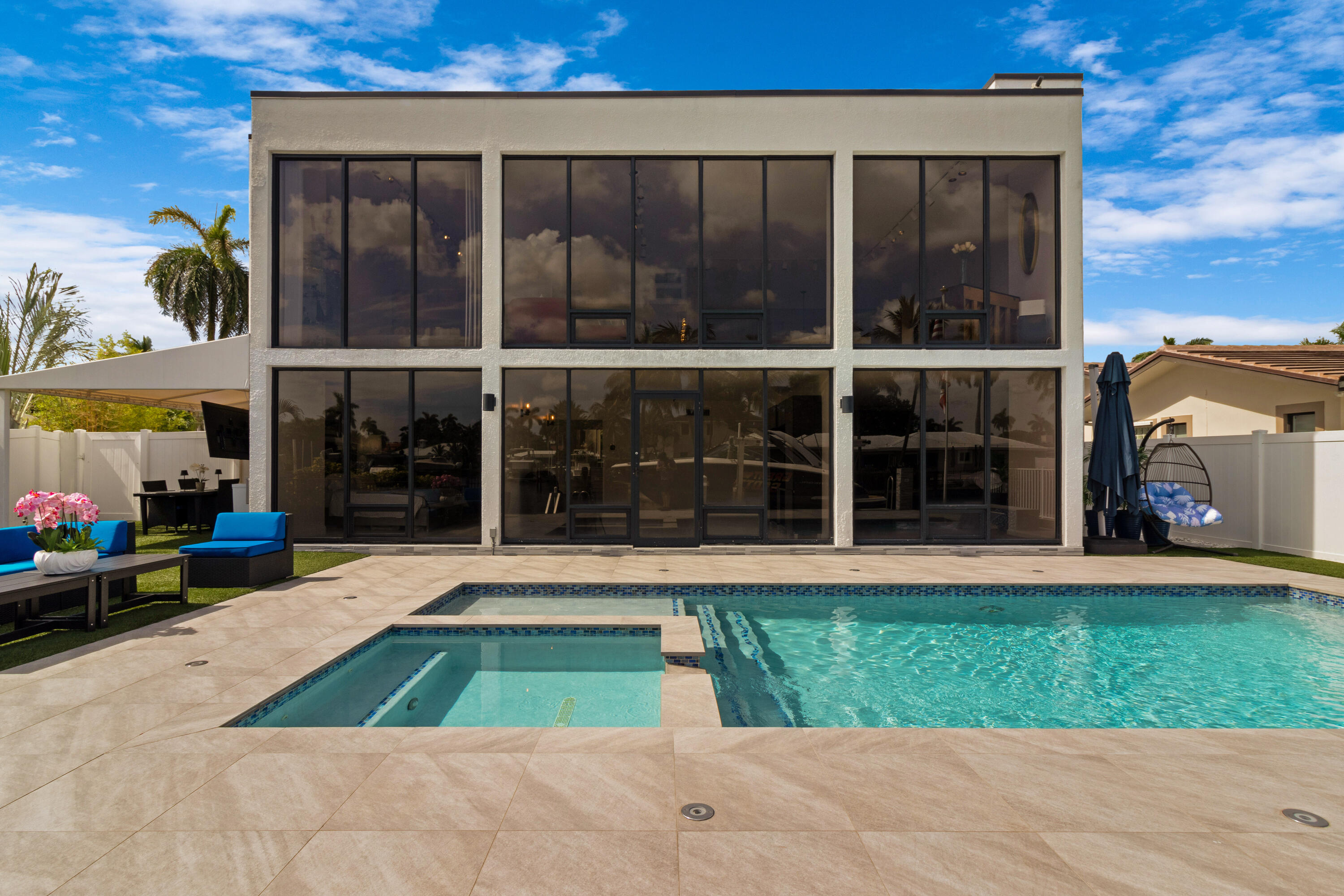 2549 Southeast 9th Street Pompano Beach, FL 33062 - Photo 48 of 73 a view of a house with a yard and a floor to ceiling window