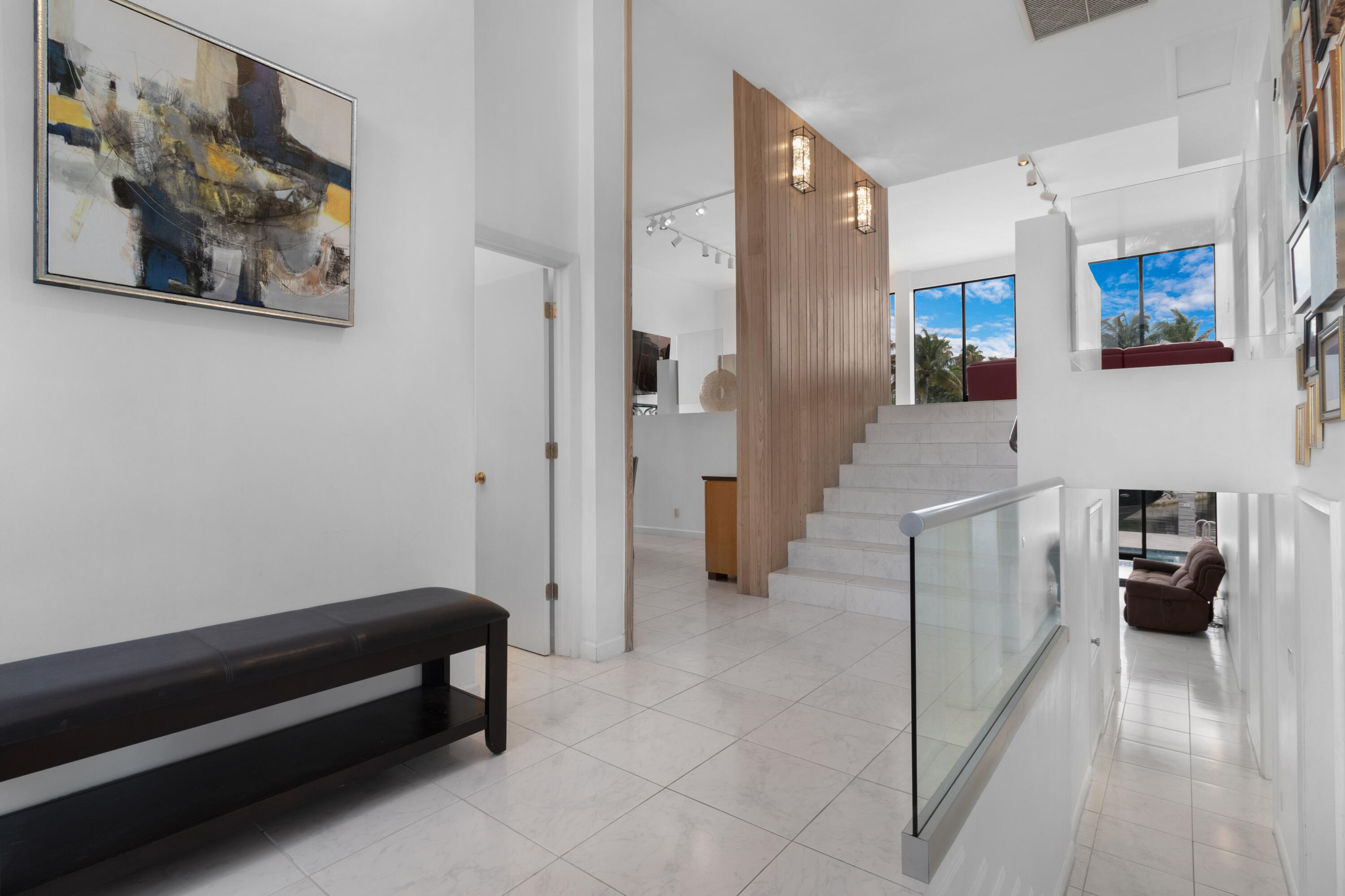 2549 Southeast 9th Street Pompano Beach, FL 33062 - Photo 8 of 73 a hallway with a couch and a view of bathroom