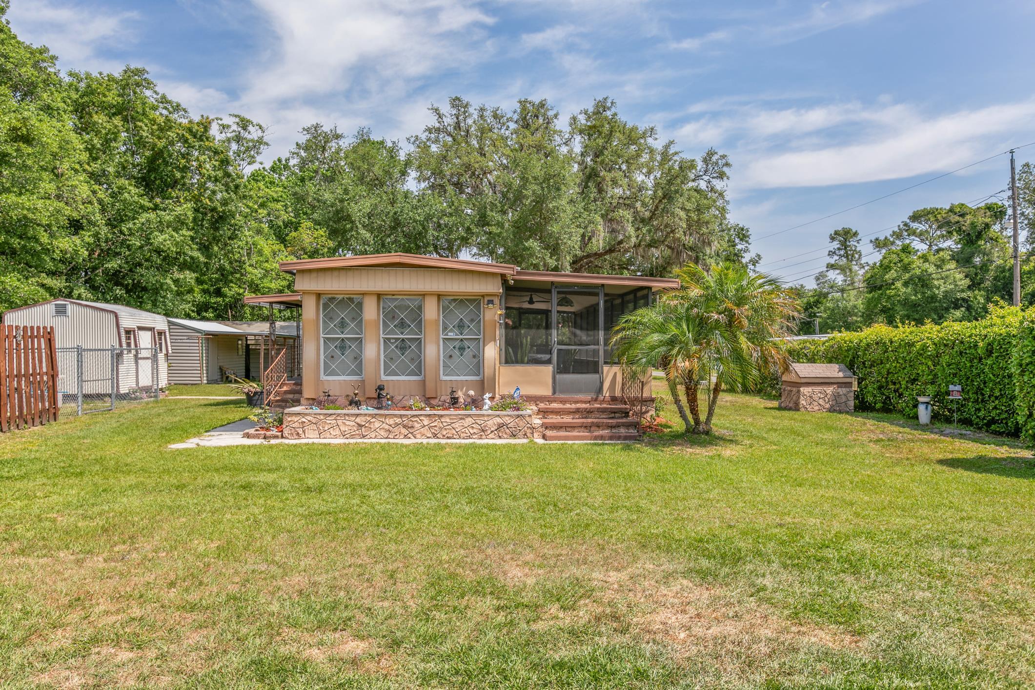 227 Spec Lane Crescent City, FL 32112 - Photo 1 of 24 a view of a house with a yard and sitting area