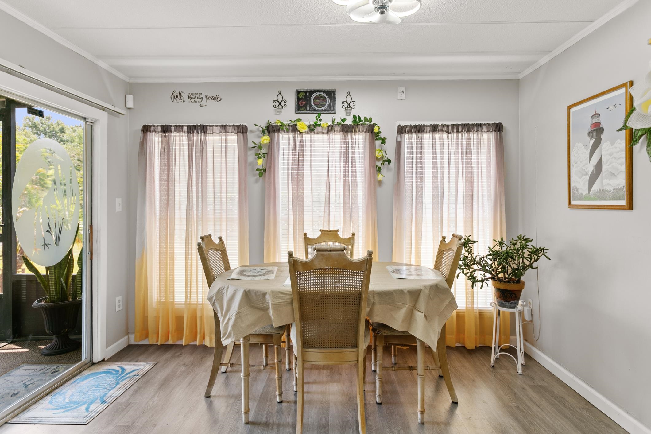 227 Spec Lane Crescent City, FL 32112 - Photo 11 of 24 a view of a dining room with furniture and wooden floor
