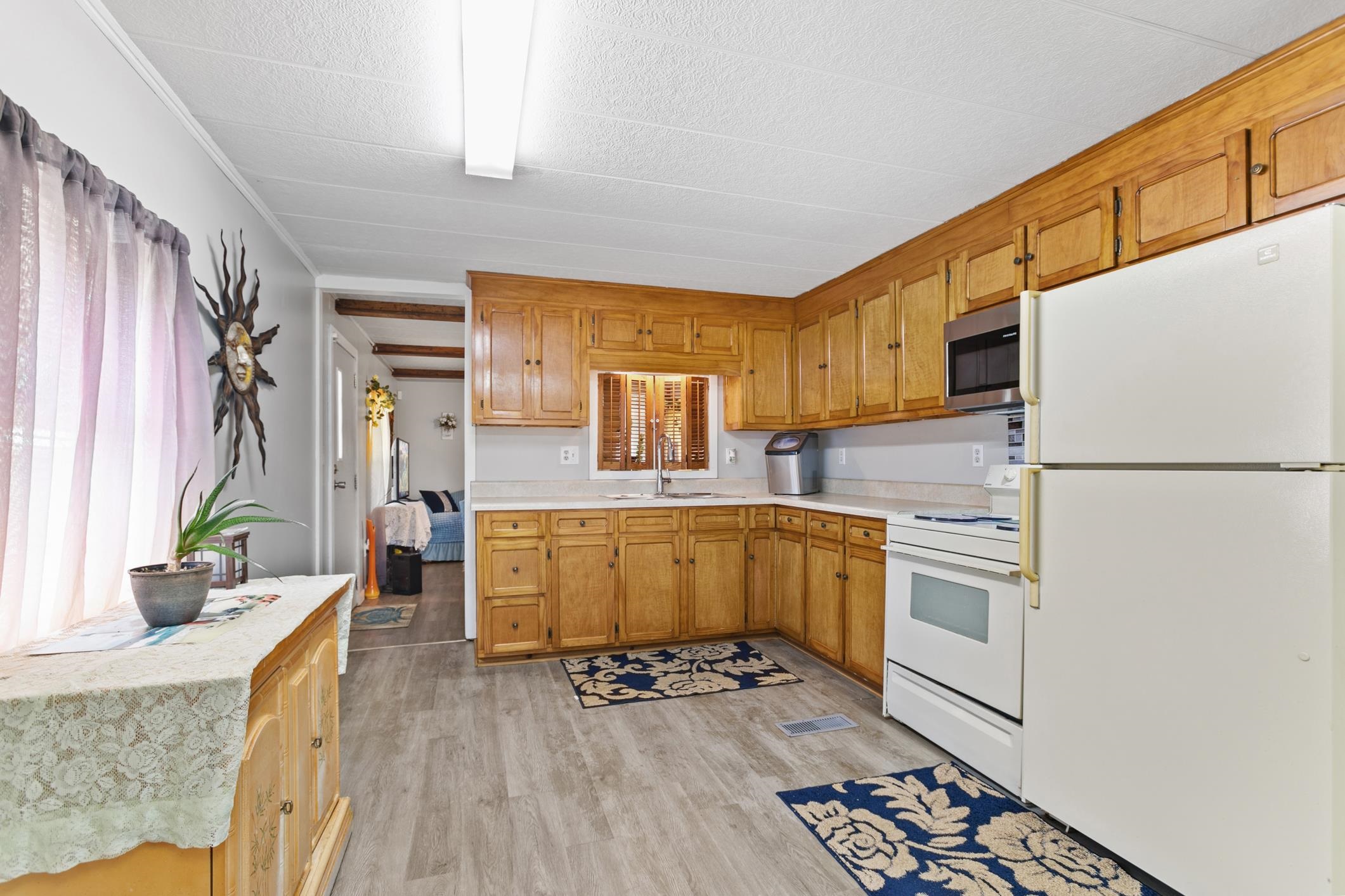 227 Spec Lane Crescent City, FL 32112 - Photo 12 of 24 a kitchen with stainless steel appliances granite countertop a refrigerator a sink dishwasher a stove and white countertops with wooden floor