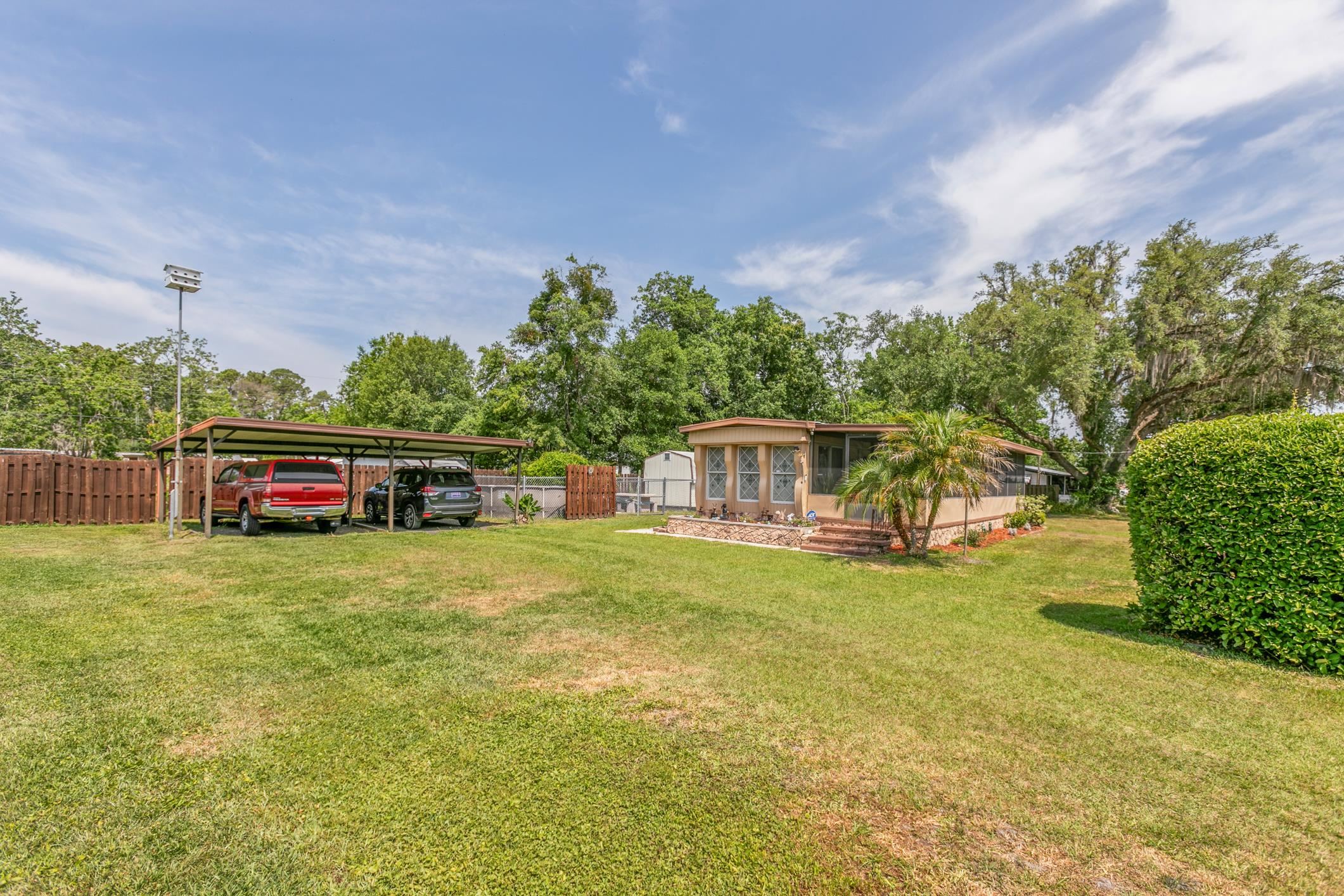 227 Spec Lane Crescent City, FL 32112 - Photo 2 of 24 a front view of a house with a garden