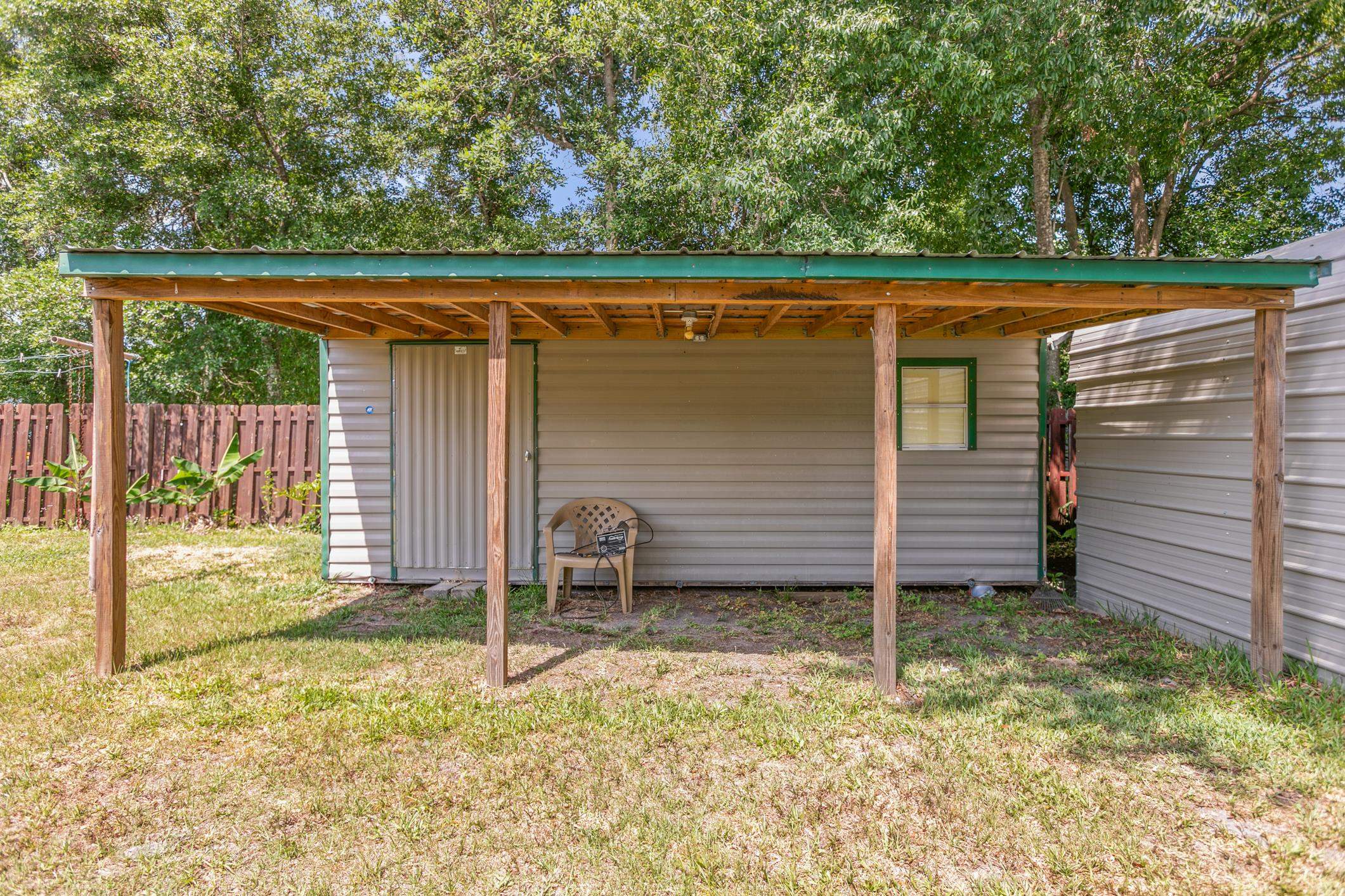 227 Spec Lane Crescent City, FL 32112 - Photo 21 of 24 a backyard of a house with lawn chairs