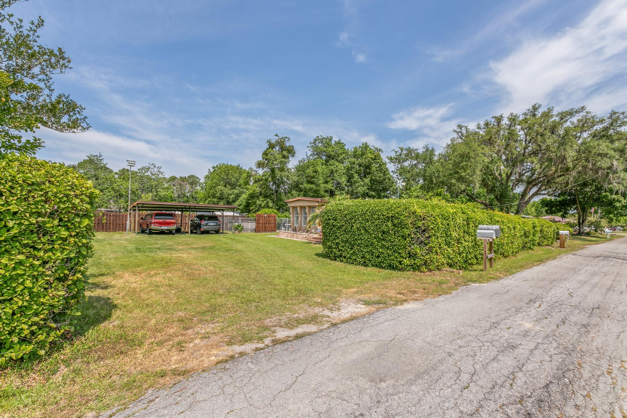 227 Spec Lane Crescent City, FL 32112 - Photo 4 of 24 a view of a backyard with plants and a garden
