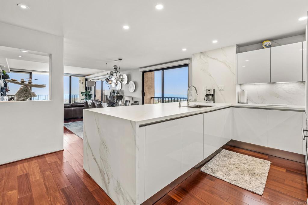a kitchen with counter top space and wooden floor