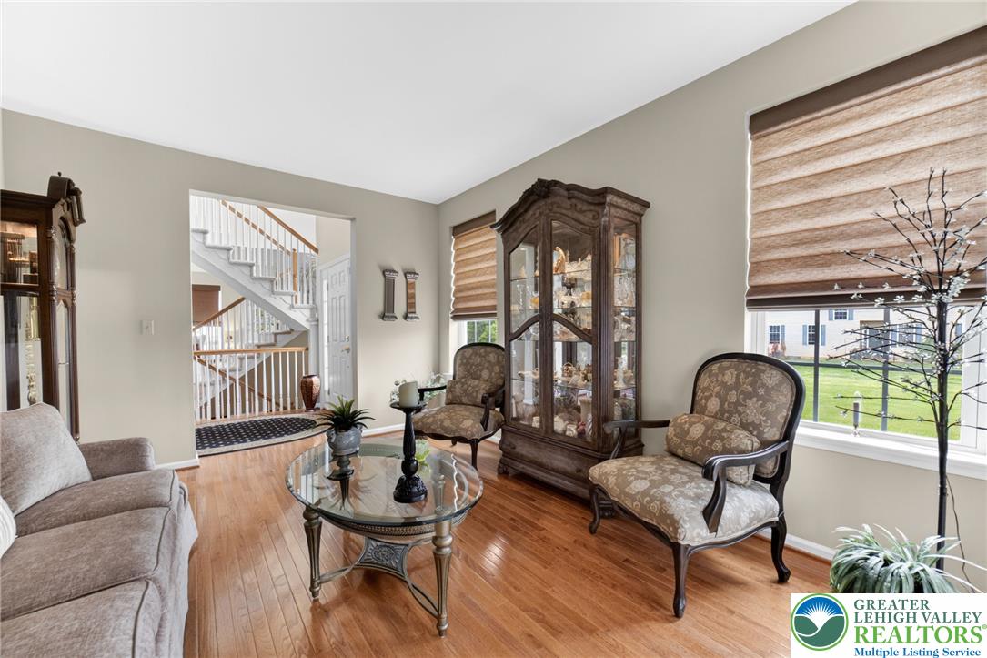 5440 Spring Ridge Drive West Macungie, PA 18062 - Photo 6 of 40 Rich hardwood floors flow through this welcoming living space, offering views to the outdoors.
