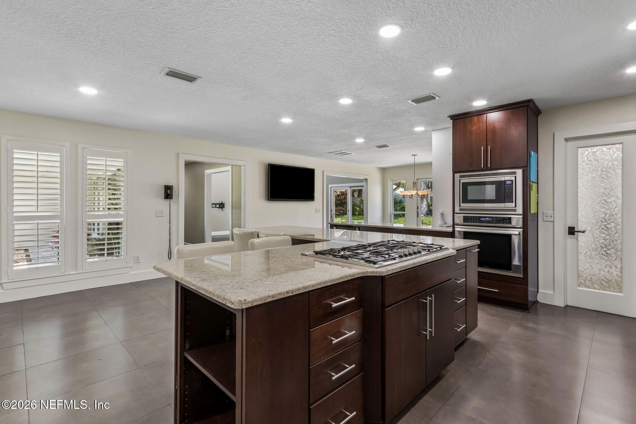 1877 Christopher Point Road South Jacksonville, FL 32217 - Photo 5 of 27 a kitchen with a stove kitchen island and a refrigerator