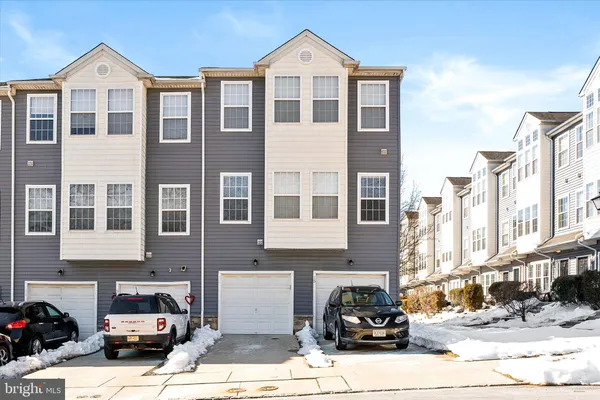 a front view of a residential apartment building with a yard